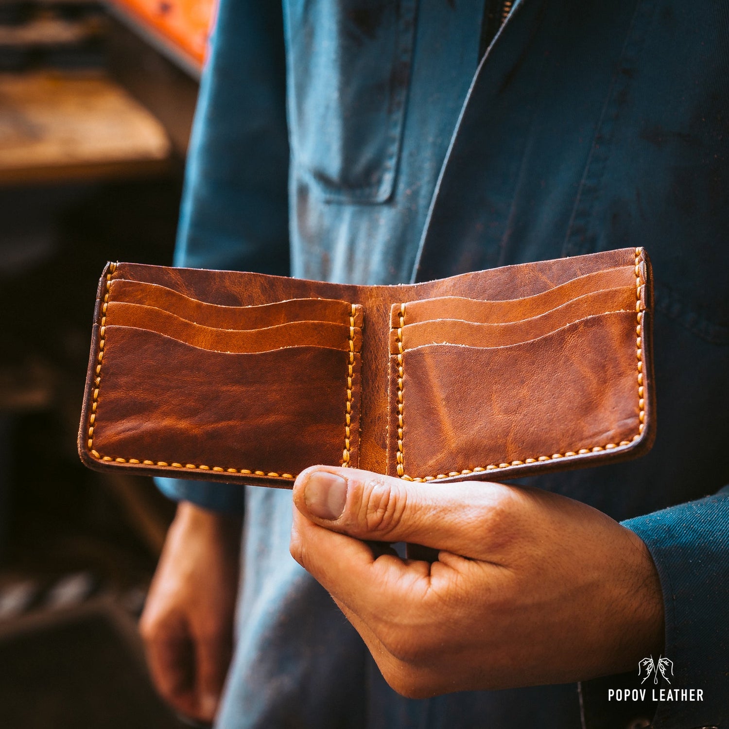 A Man Holding an English Tan Wallet