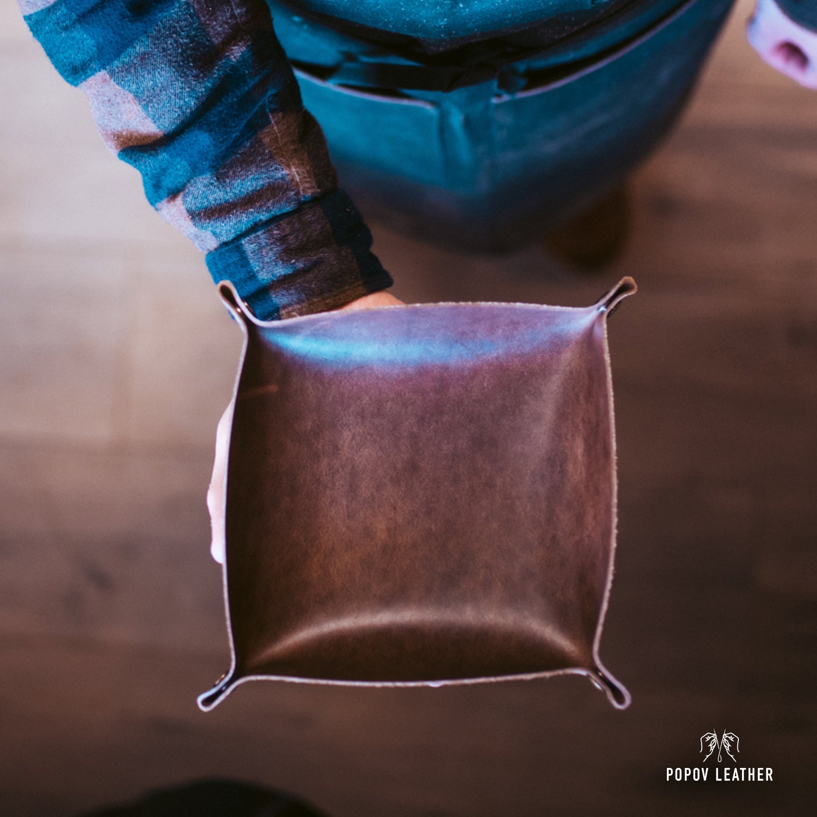 Man holding a leather valet tray